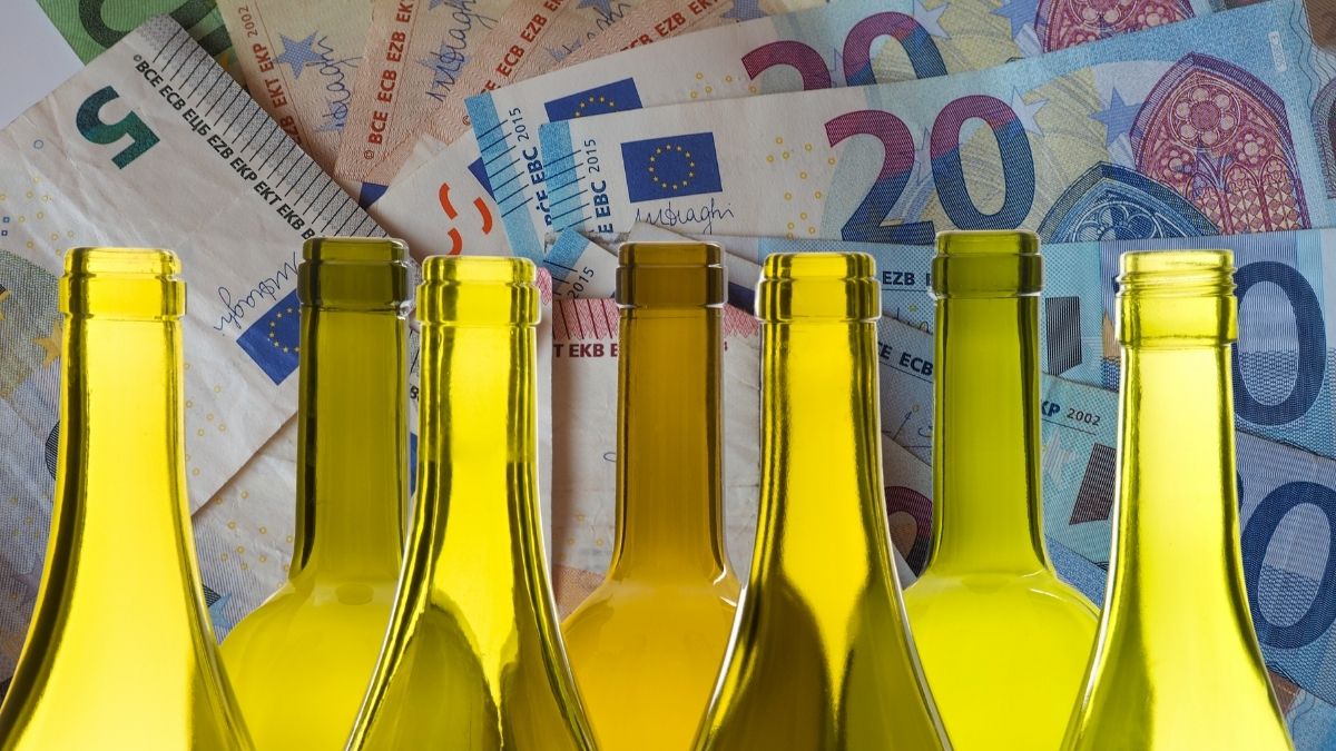 Leere Weinflaschen vor Euroscheinen