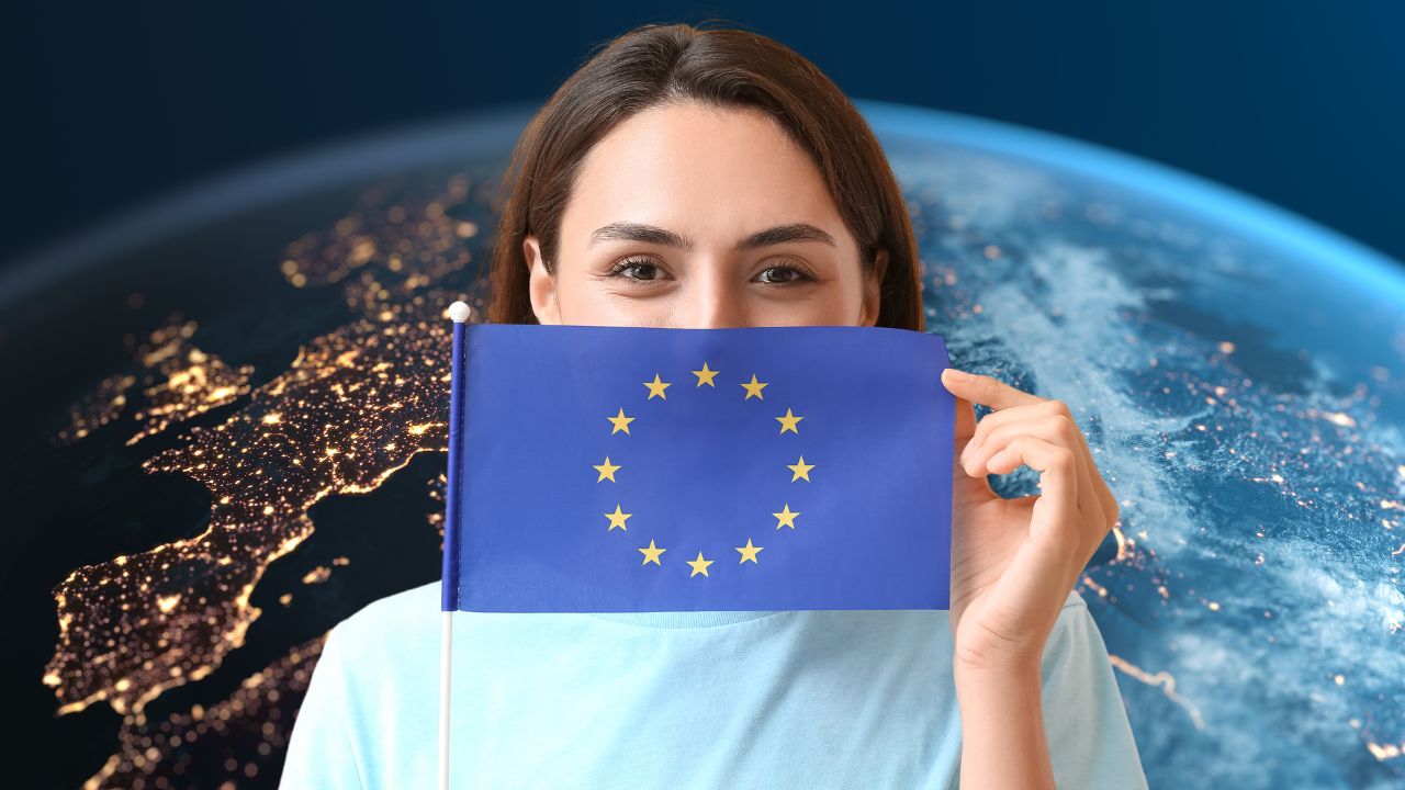 Europa und die umliegenden Gebiete aus dem Weltraum. Im Vordergrund eine junge Frau mit der Flagge der Europäischen Union.