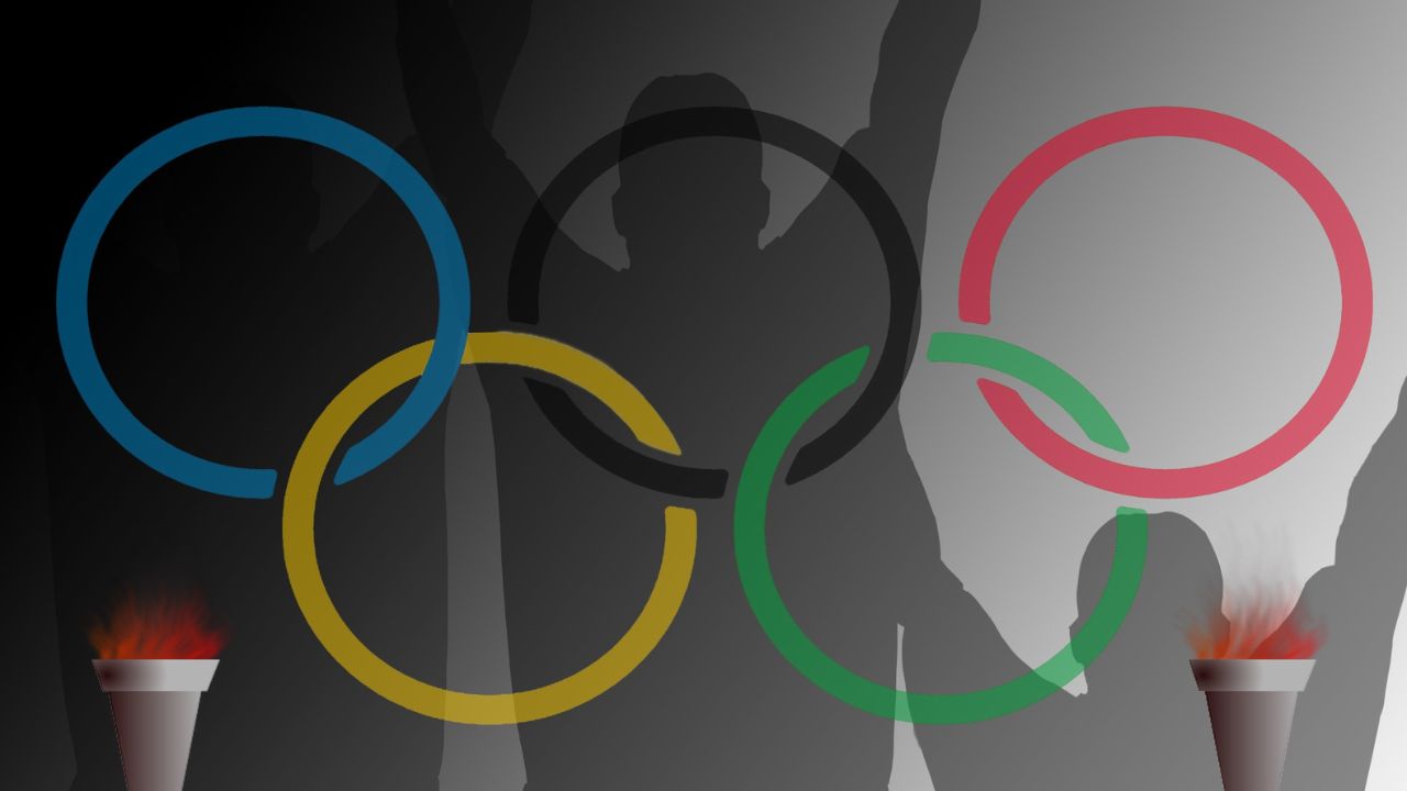 Grafik mit den Olympischen Ringen und Schatten von Personen auf dem Siegertreppchen.